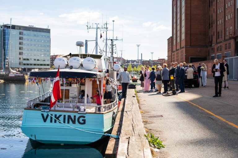 Et selskab venter på at komme ombord på en båd